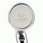 Lumora Shower showerhead face with one-touch stop button