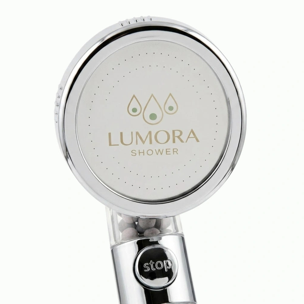 Lumora Shower showerhead face with one-touch stop button